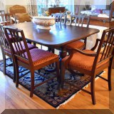 F24. Mahogany double pedestal dining table and 8 chairs. Table measures 30”h x 62”w x 42”d Chairs measure 37”h 